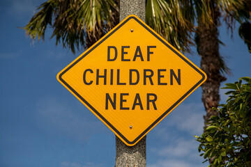 Yellow warning sign stating Deaf Children Near