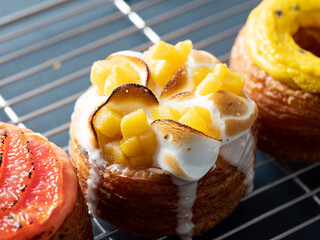 Assorted croissant donuts on a grill plate