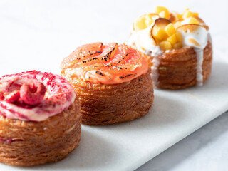 Assorted croissant donuts on a marble background