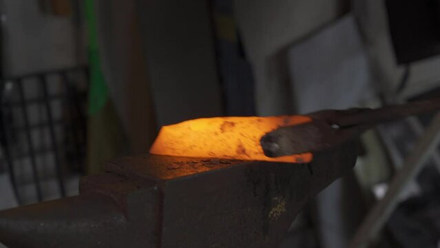 Blacksmith hitting a hot metal rod, 4k footage