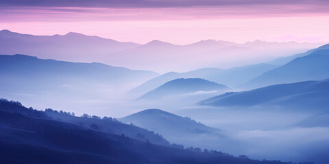 The mountains are shrouded in mist, and the last traces of daylight lend a tranquil, mystical quality to the scene. A twilight shot of autumn mountains under a fading pink and purple sky.