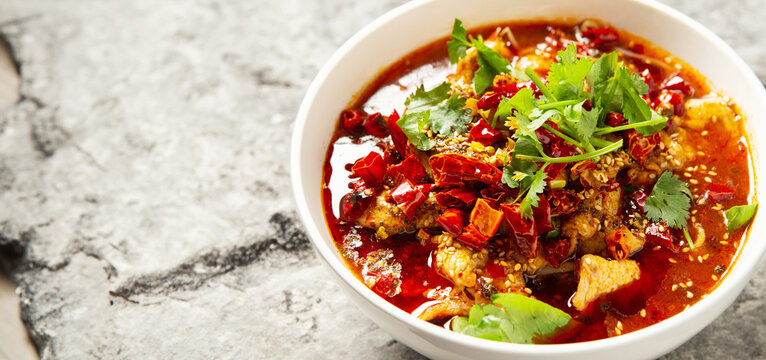 skewered vegetables and meat cooked in a hot and spicy soup