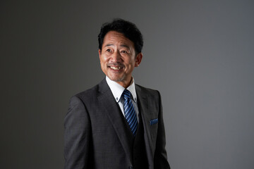 中年の笑顔のビジネスマンのポートレート　黒背景