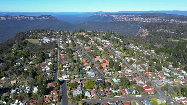 Katoomba, Australia: Aerial drone footage of the Katoomba town by the famous blue Mountains in the Sydney region in New South Wales in Australia on a sunny day. Shot with a tilt up motion