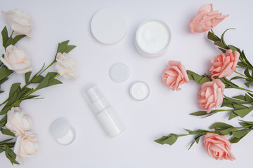 Moisturizing care skincare face cream for healing complicated troubled skin type. cosmetic lotion with flowers, green leaf. skin care beauty treatment with jar of body moisturizer. Flat lay, Top view