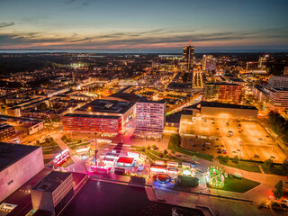 Almere city center illuminated in the evening. Suburban city near Amsterdam, The Netherlands. Aerial view.