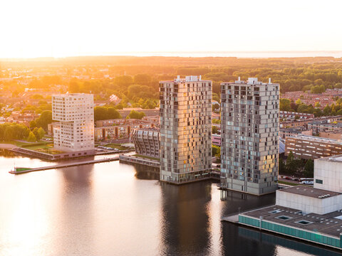 Modern architecture of Almere city, Flevoland, The Netherlands. Aerial shot at sunset.