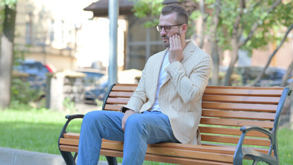Fototapeta premium Middle Aged Man with Toothache Sitting Outdoor