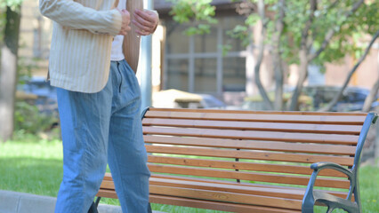 Middle Aged Man Coming and Sitting on Bench