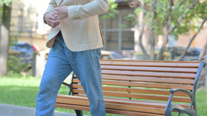 Middle Aged Man Standing up and Leaving Bench Outdoor