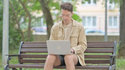 Fototapeta premium Casual Young Man Working on Laptop Outdoor