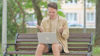Fototapeta premium Casual Young Man Shocked by Loss on Laptop Outdoor