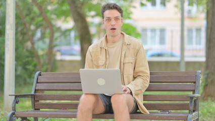 Fototapeta premium Rejecting Modern Young Man in Denail while Sitting Outdoor