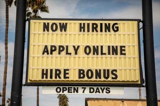 Sign stating Now Hiring With a Sign On Bonus