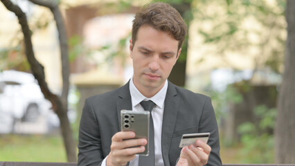 Businessman Shopping Online with Phone Outdoor
