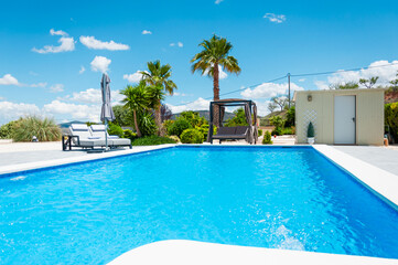 beautiful summer landscape with a swimming pool and palm trees, there is a place for an inscription