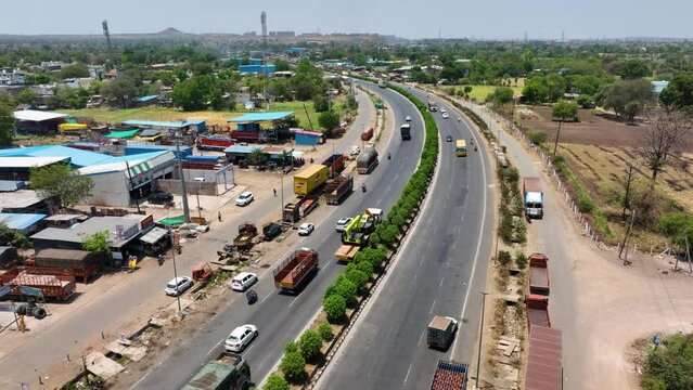 Aerial Shot Of Delivery Trucks Driving Along A Highway In Maharashtra, India