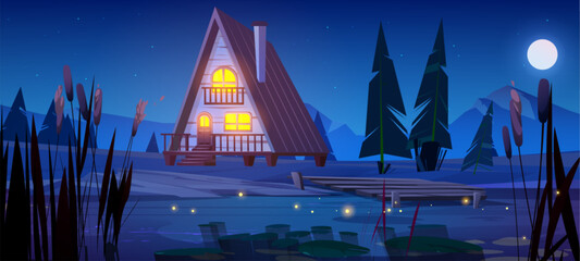Night wooden house near mountain lake. Vector cartoon illustration of cozy glamping hut with yellow light in windows and porch, pier above water, fir trees and grass, full moon glowing in starry sky