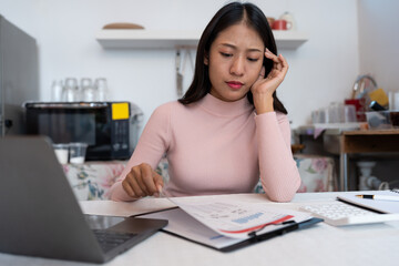Tired business woman sleepy headache Tired and having office syndrome while sitting at home working with laptop computer and business paperwork.