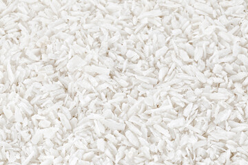 Fresh coconut flakes on white background, top view. Close-up - obrazy, fototapety, plakaty