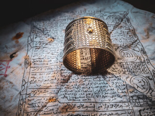 an ancient bracelet on a tattoo cloth inscribed with Arabic letters (amulet)