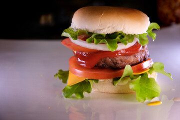 Professional cook folds a burger on board in restaurant kitchen close up. High quality 4k footage