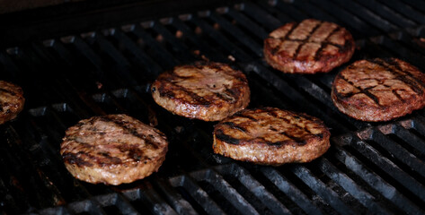 Hamburgers cooling on flaming grill, slow motion. Shot on Phantom Flex 4K camera. High quality 4k footage