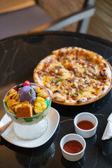 halo halo with sisig pizza on a table