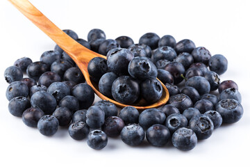 Fresh blueberries in wooden spoon