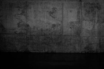 Grungy dark concrete wall and wet floor