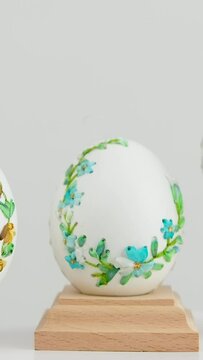 close-up of three white eggs on stands embroidery with ribbons on an eggshell example technology beautiful ornament handmade Easter holiday easter eggs decoration drawing on eggs as gift