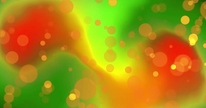 Yellow bokeh light spots over glowing green and red organic shapes