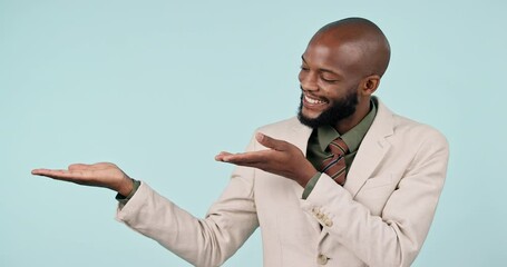 Pointing, hand and a business man in studio for advertising, announcement and mockup space. happy, corporate and a professional person from Kenya on a blue background with empty palm for choice