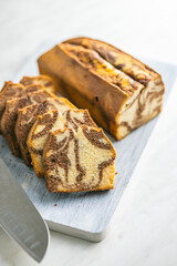 Marble sponge cake. Cake with cocoa and vanilla taste on cutting board.