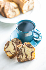 Marble sponge cake and coffee cup. Cake with cocoa and vanilla taste.