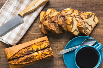 Marble sponge cake and coffee cup. Cake with cocoa and vanilla taste. Top view.
