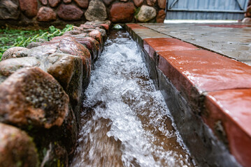 Water flows into the drainage system for domestic wastewater and rainwater.