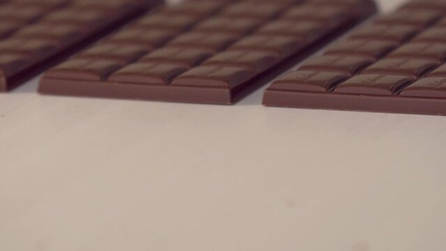 static slow motion close up shot of freshly made chocolate bars on the conveyor line