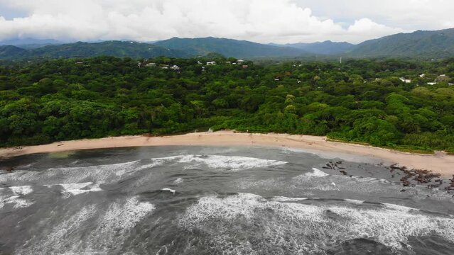 Pristine beach in Playa Guiones, vast Costa Rica landscape backdrop