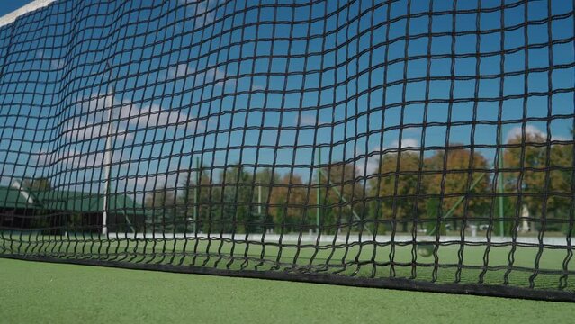 Sunny day, the ball hits the net, tennis traning game, outdoor court, tennis player hits the ball into the net, a lose shot.