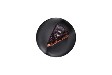 A piece of fresh delicious cake with nuts and chocolate on a black plate