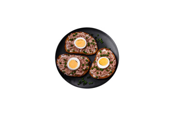 Delicious healthy sandwich with tuna, croutons, boiled egg, herbs and butter