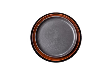 Empty black plate over dark stone background with free space. Top view
