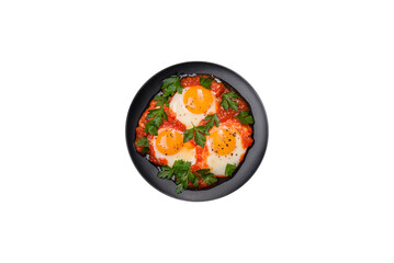 Shakshuka, a dish with fried eggs with tomato sauce, sweet pepper, garlic, onions, spices and herbs