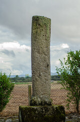 Fototapeta na wymiar Roman roman milestone in the plain of A Limia. Galicia, Spain. Via XVIII, Roman road Cloudy day