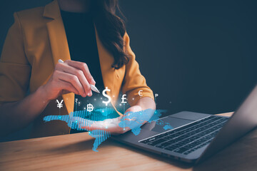 Businesswoman hand holding virtual world with international currency include dollar yuan yen euro...