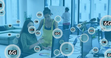 Animation of 6g text in circles, diverse female coworkers discussing reports on desktop in office - Powered by Adobe