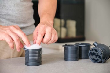 Man hand setting up new filter wool for mechanical prefiltration of the fine dirt particles at his fish tank at home. Fishkeeping concept.