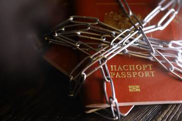 Obraz na płótnie Canvas Russia Sanctions and banned russian people, Russian Federation passports with padlock and chain. Text translation Russian Federation