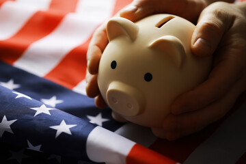 Closeup view of an American flag with a pink piggy bank for various financial concepts.